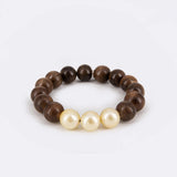 Luxuriöses Armband mit Sandelholz Perlen und Goldenen Südseeperlen -  Rising Sun Amazone Bracelet